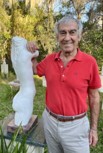 Sculptor Enzo Torcoletti with one of his art pieces